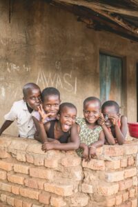 five boys beside brick wall